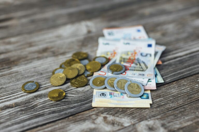 Euro banknotes and coins on a desk